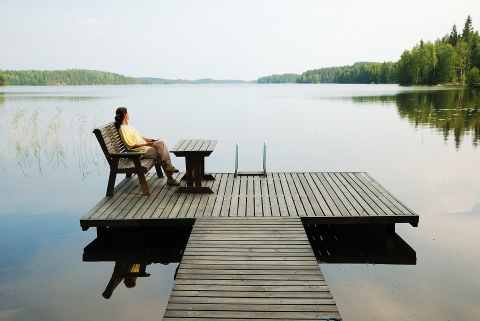 Lake Platform Wooden Platform Woman Resting Finland is one of the safest countries in the world. Moreover, It's one of the best places to travel alone female and it's a favorite destination for solo female travelers looking for an adventure.